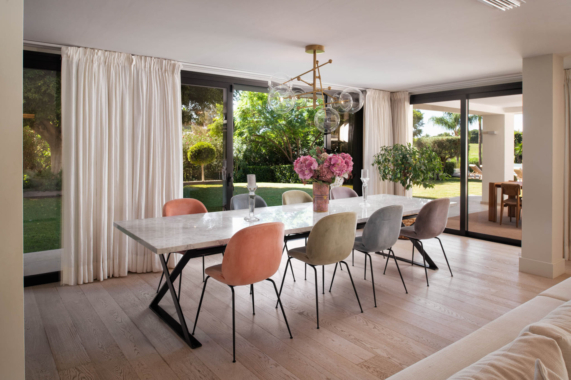 The dining room with wide glass doors bringing the garden into view.